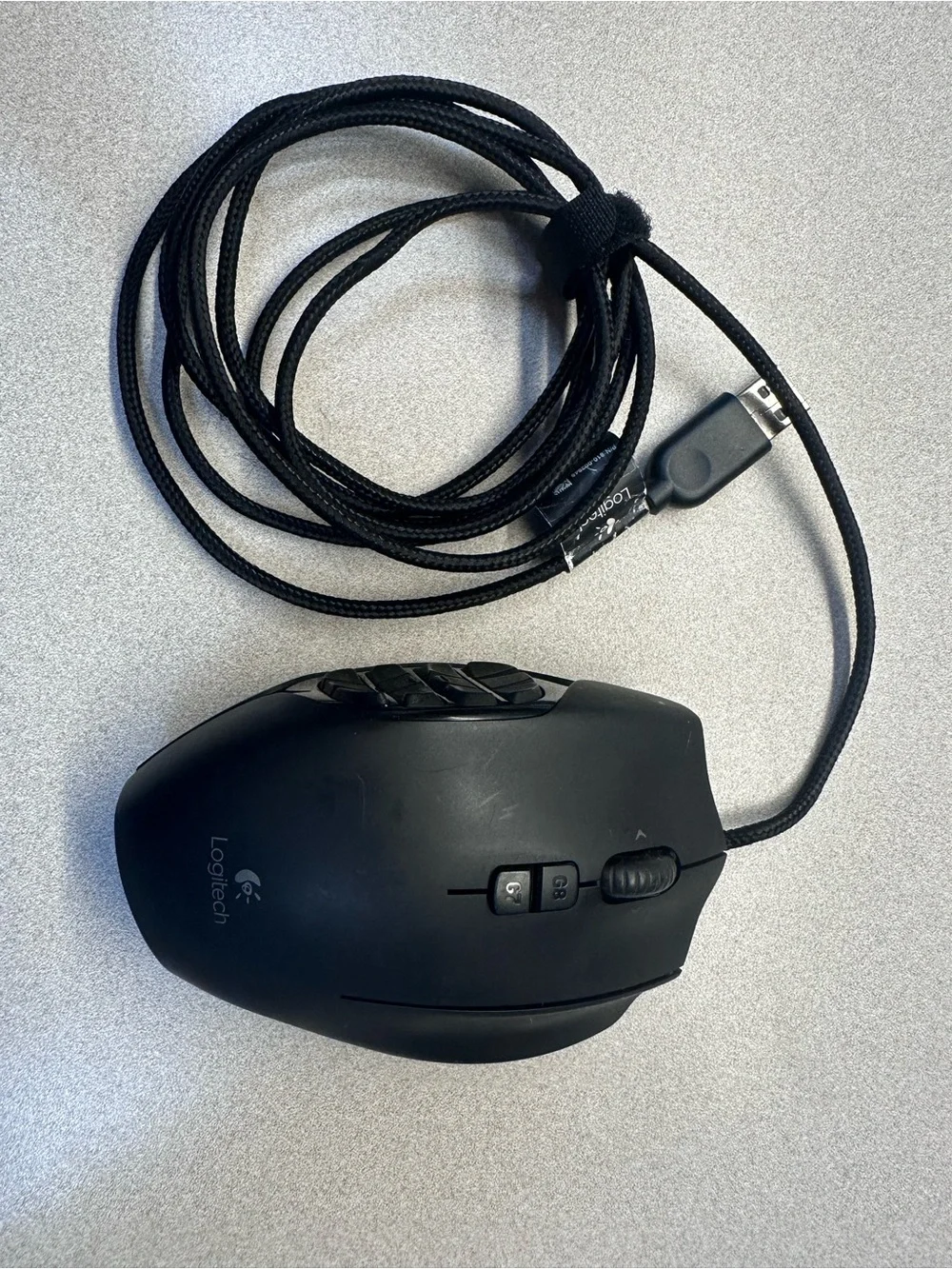 Logitech G600 Black Wired Ergonomic Gaming Mouse with 12 button thumb grid.